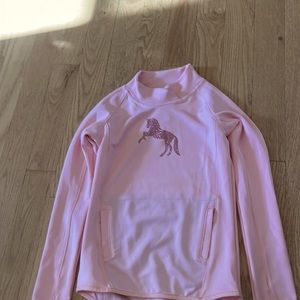 Pink sweater with pink glitter horse located in the center